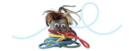 A rock wearing googly eyes and hair, covered in rubber bands, with a blue decorative loop in the background. 