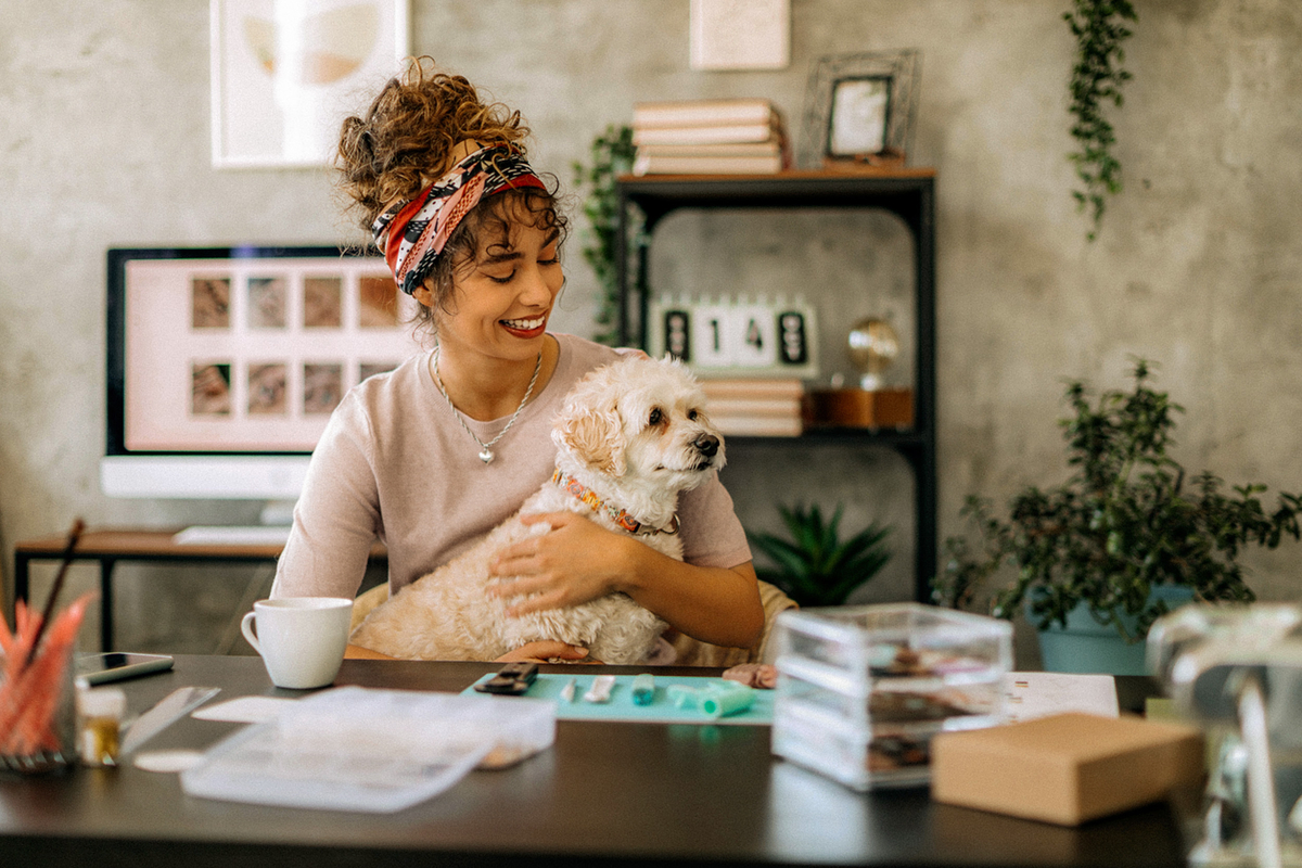 Woman smiling holding dog